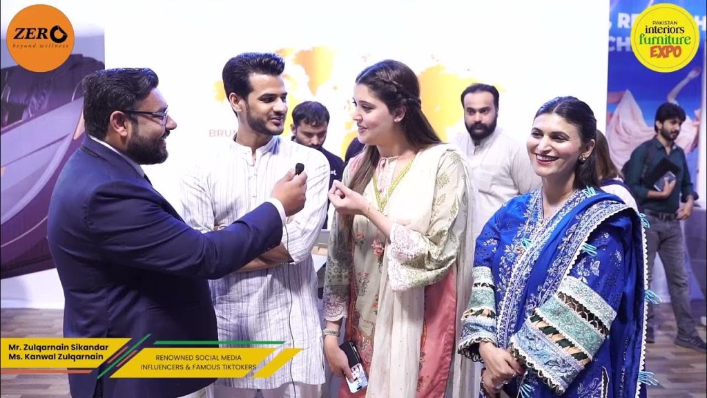 Exhibitor speaking with visitors at a Pakistan Interiors Furniture Expo stand